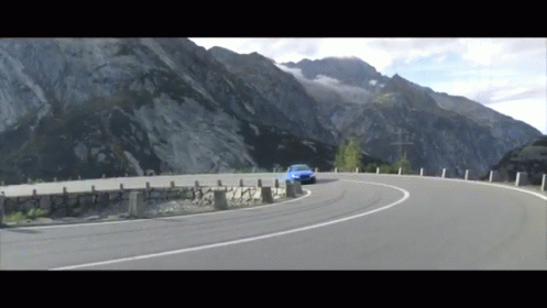 a car driving on a mountain road, in a blurry po