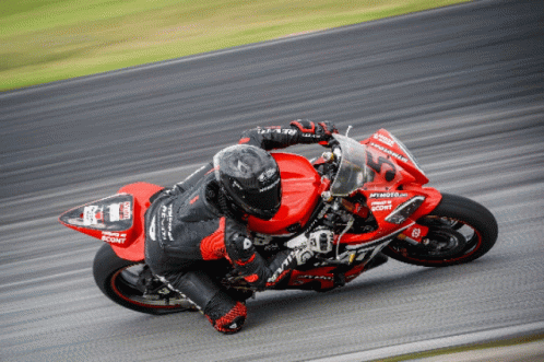 a motorcyclist is riding down a racing track