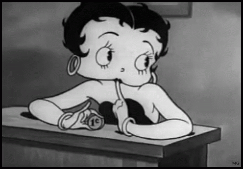 a cartoon girl sitting at a desk writing on a piece of paper