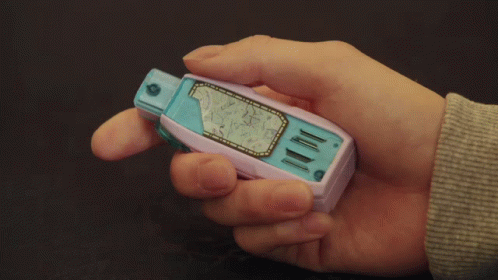 a man holding a game boy on its finger