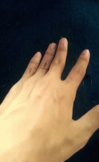a creepy hand with white skin and black nails