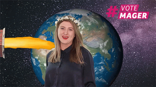 a woman is holding a toothbrush with the same color as a model of a planet