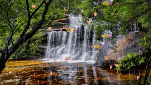 a water fall surrounded by some trees and flowers