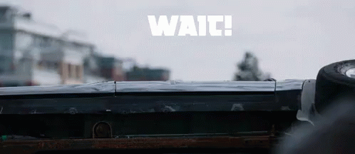 the back of a vehicle in front of a building with the word waii written over it