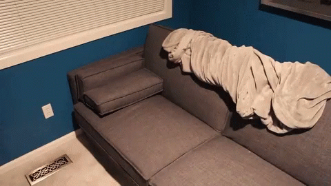 this is a sofa with a blanket on it