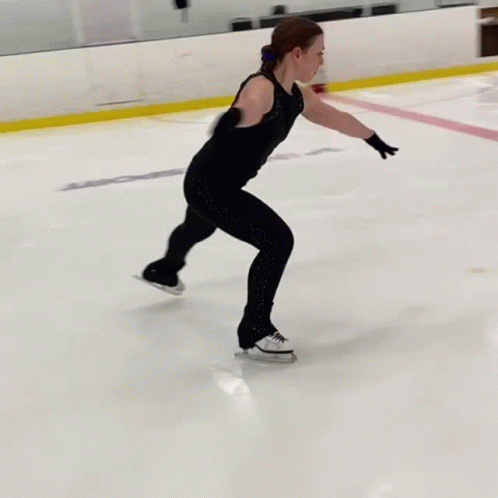 a young person on an ice rink with an oncoming skate board