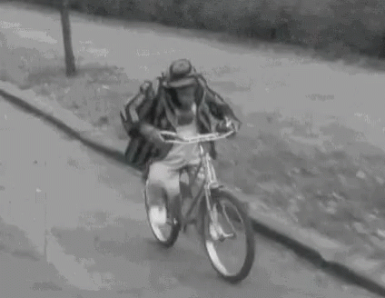 a man riding a bike down a road