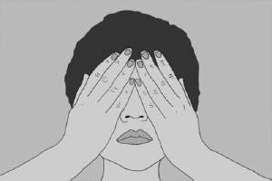 a black and white po of a person covering their face
