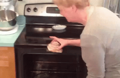a man in white is cleaning up an oven