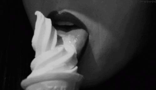 a woman's lip is being hed over with a small ice cream cone