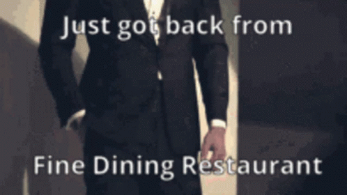 a man standing in front of a wall with the words just go back from fine dining restaurant