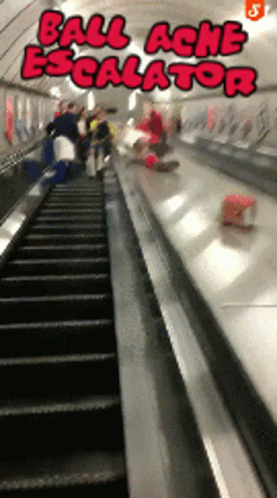 people moving down an escalator in an underground area