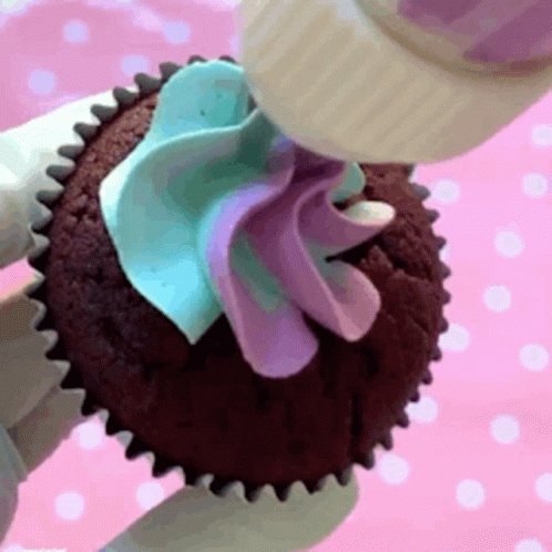 an image of someone decorating a cupcake
