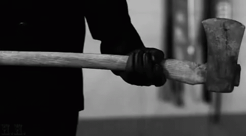 an old hammer with a handle holding an object