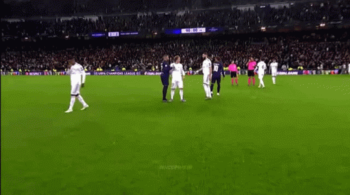 there are men playing soccer in front of an audience