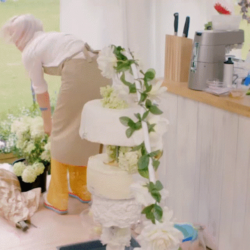 a woman is making an elaborate cake for someone to make