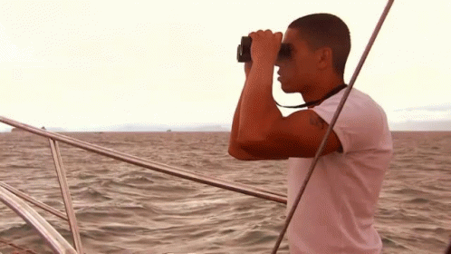 a man taking pictures from the front of a boat