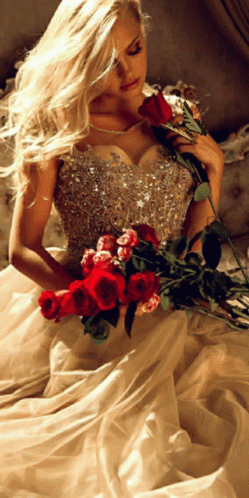 a woman wearing a wedding dress with flowers