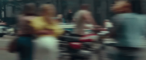 blurry image of a motorbike and people on the street