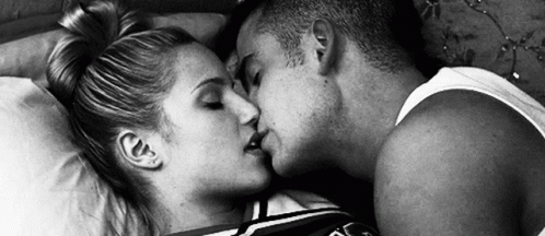 a black and white po of a man kissing a woman