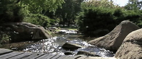 a river running between two large rocks with water
