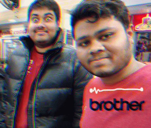 two guys standing side by side and wearing shirts with the word brother on them