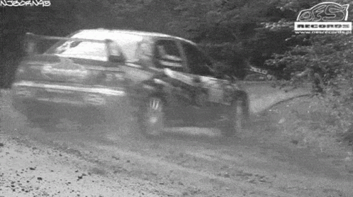 an image of the two cars driving in the forest