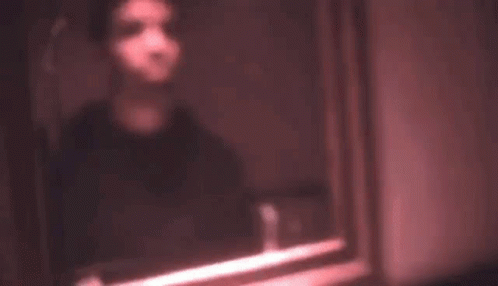 blurry pograph of a man with a cellphone on his face