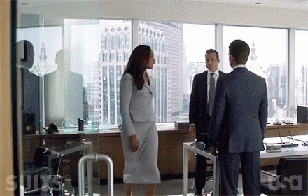 three business people standing around in a room