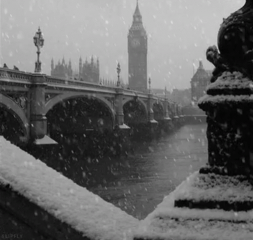 a bridge and a clock tower in the snow