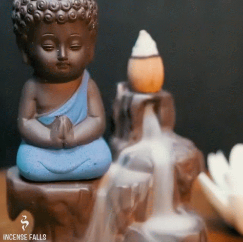 small blue statue and water fountain with little buddha statue