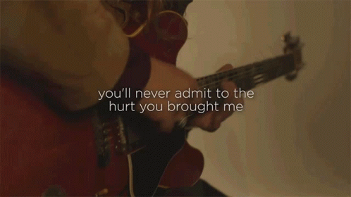 a guitar player is playing a song with his words