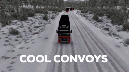 an aerial view of trucks driving on a snow covered road