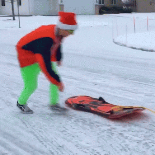 a man skating while hing on a blue sled