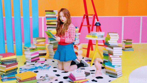 the girl stands on a floor that is made up of many books