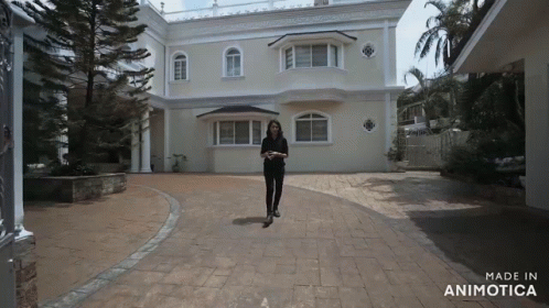 a person standing on a skateboard in the middle of a driveway