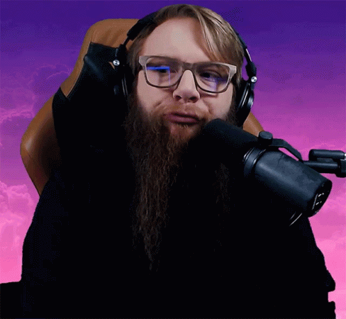 a man with long hair wearing headphones and glasses