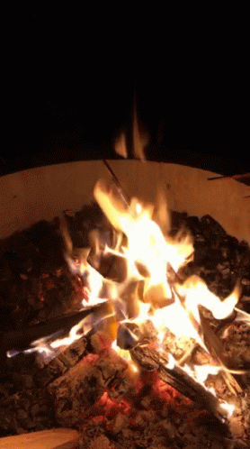 a lit fire with chunks of coal and flames burning