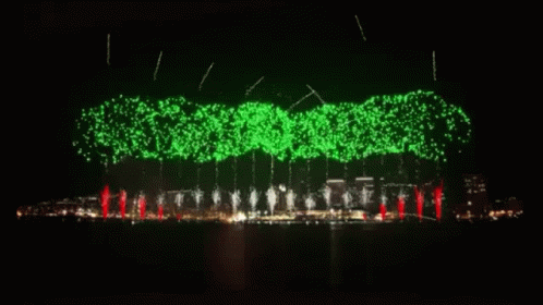 fireworks display in the sky with green and white lights