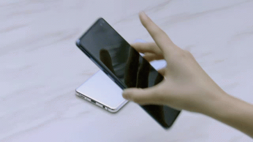 hand holding and touching a smartphone with its screen