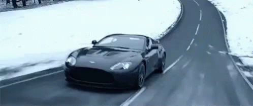 a car driving down the road in the snow