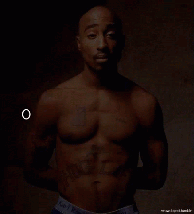 a shirtless black man with  posing for the camera