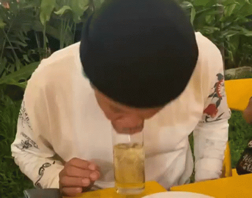 a person blowing bubbles on a white cake