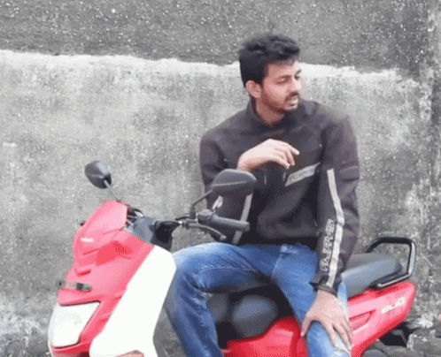 a man sitting on the seat of a motorcycle