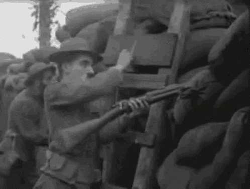 a soldier holding a gun next to a wall of military chairs