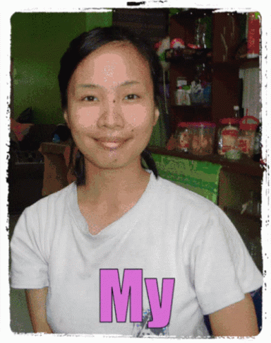 a  in a white tshirt with pink lettering on her face