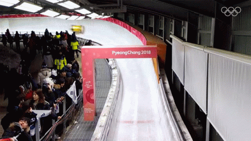 a snowboarder is going down an artificial slide