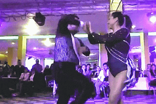 two people in costume dancing at an event