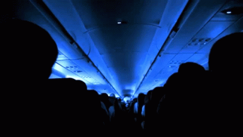 an airplane with lights on the ceiling and on one side of the seats
