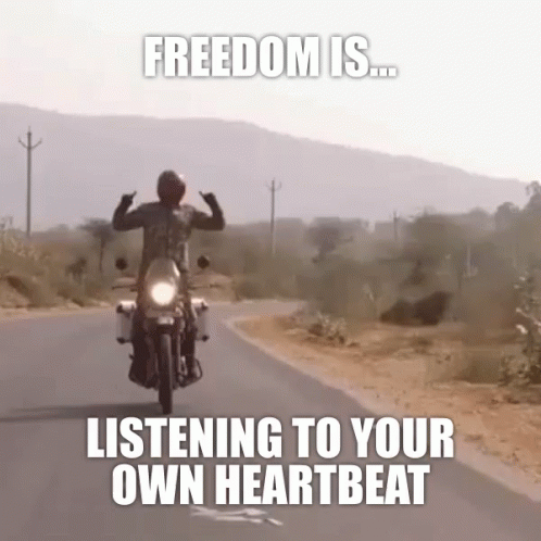 a person on a motorcycle with the caption, freedom is listening to your own heartbeat